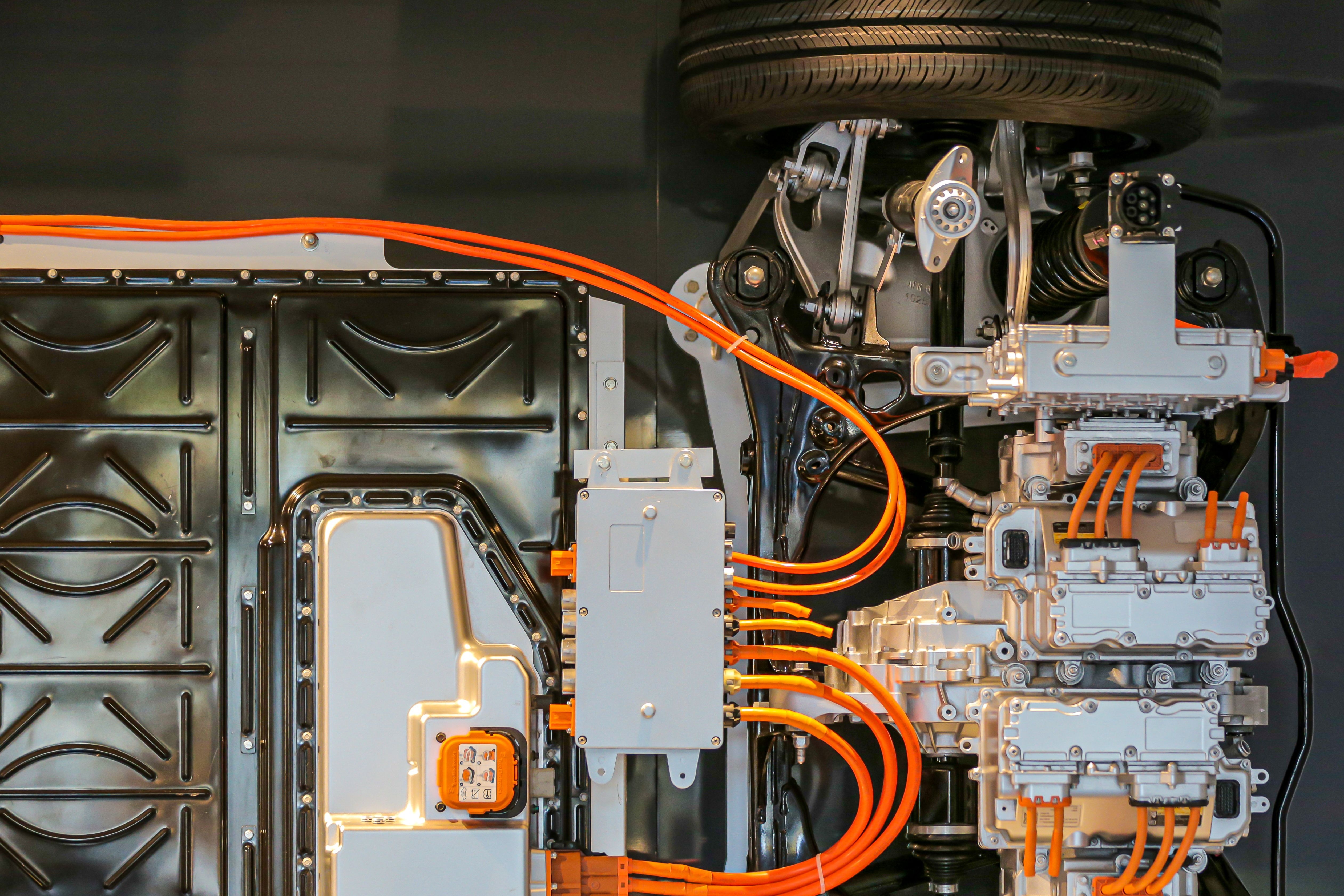 some wires are on top of an electronic device with a car wheel